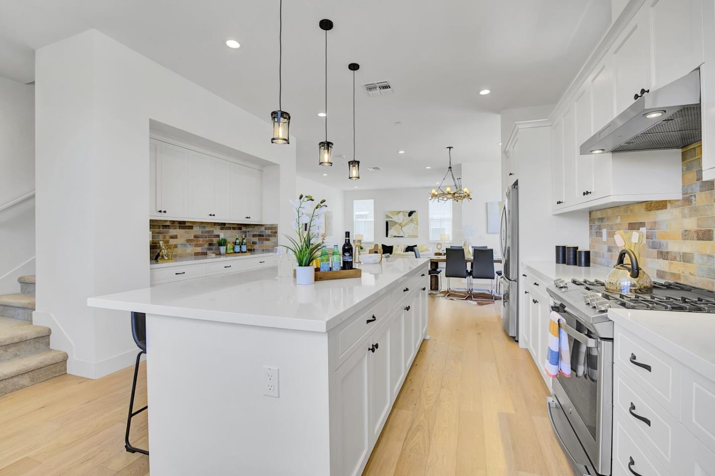 37356 Suncrest Street Newark, CA 94560 - Photo 14 of 47 a kitchen with stainless steel appliances sink stove and white cabinets