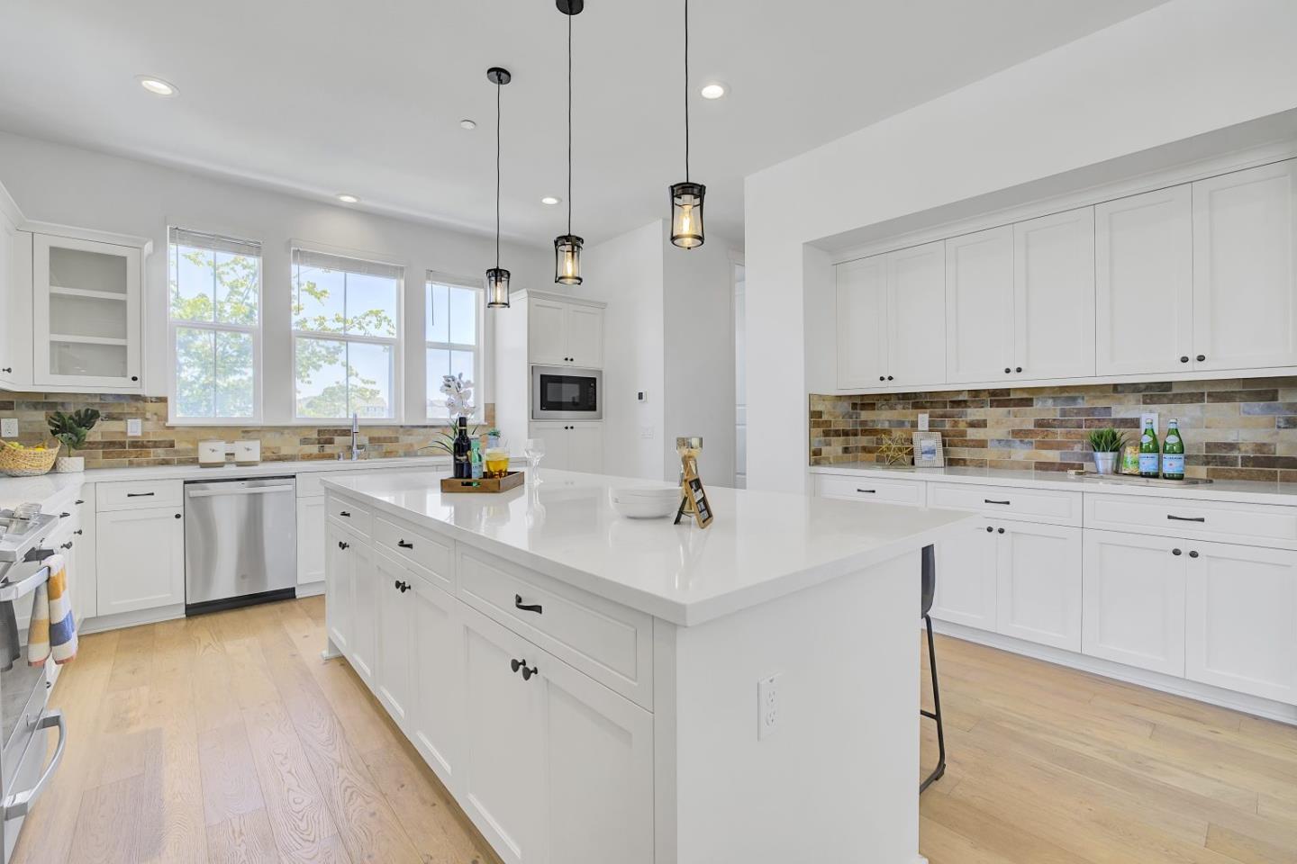 37356 Suncrest Street Newark, CA 94560 - Photo 17 of 47 a kitchen with white cabinets and white appliances