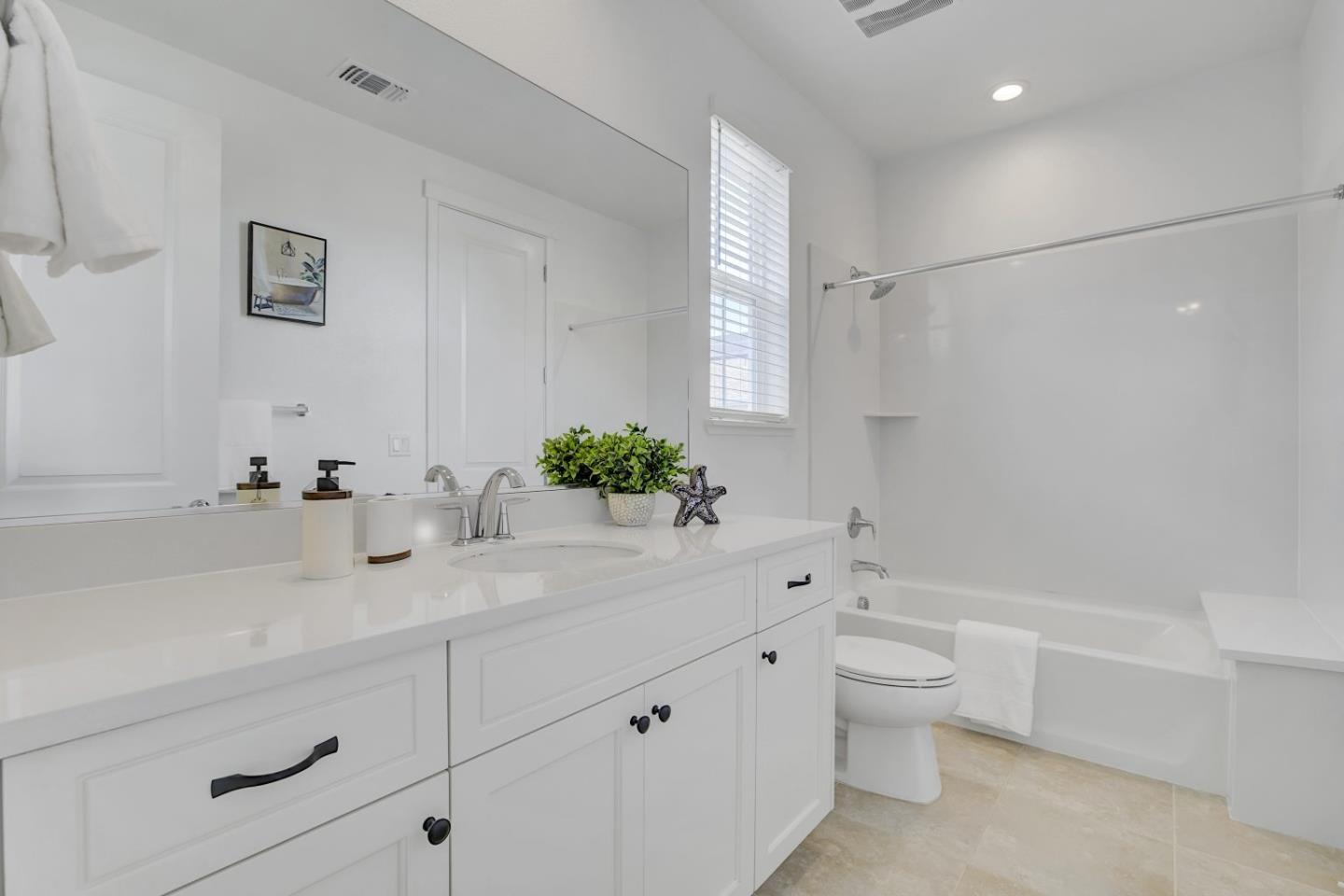 37356 Suncrest Street Newark, CA 94560 - Photo 28 of 47 a bathroom with a sink a large mirror and a bathtub