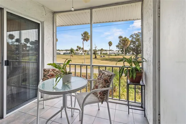 a dining room with furniture and a floor to ceiling window