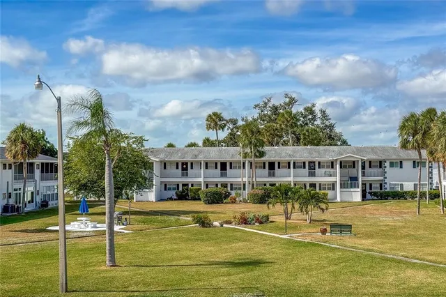 a view of a house with swimming pool and sitting area