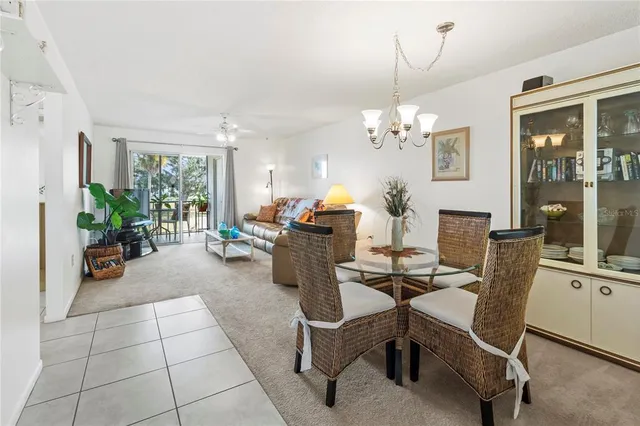 a view of a dining room with furniture and chandelier