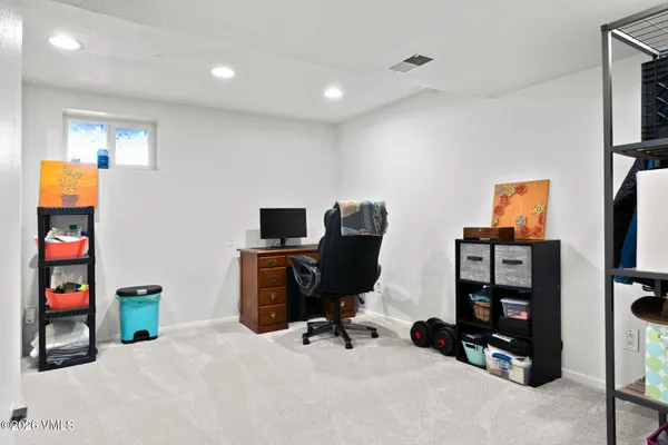 a view of a workspace with furniture and clutter