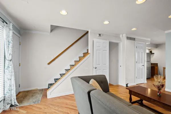 a living room with furniture and stairs