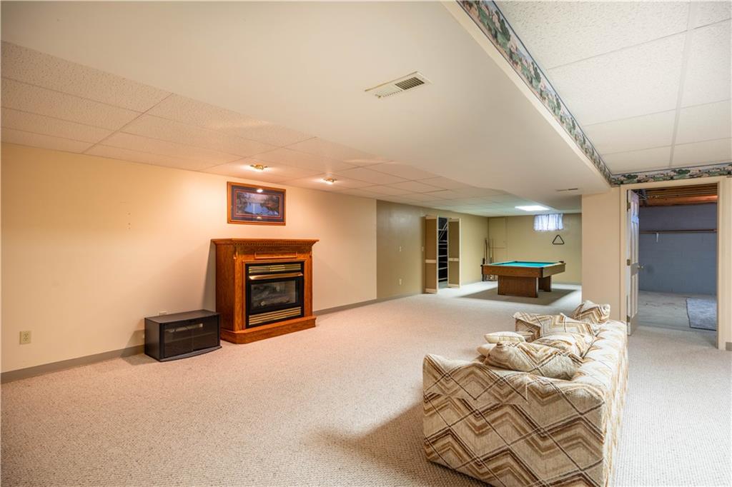 4487 Battle Ridge Road Oakdale, PA 15071 - Photo 31 of 46 a bedroom with furniture and a fireplace