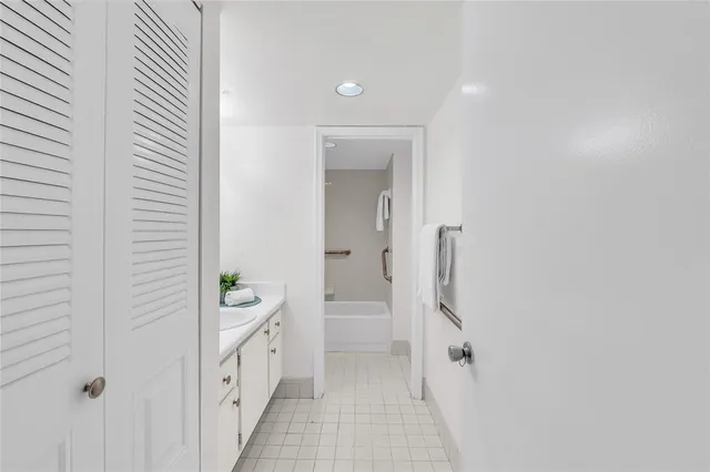 a spacious bathroom with a double vanity sink and a mirror