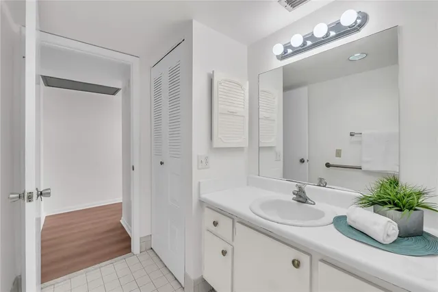 a bathroom with a sink double vanity granite tub and shower