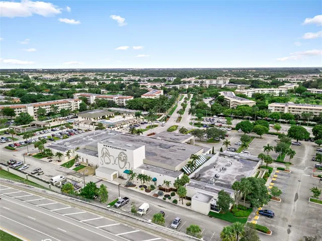 an aerial view of residential building with green space