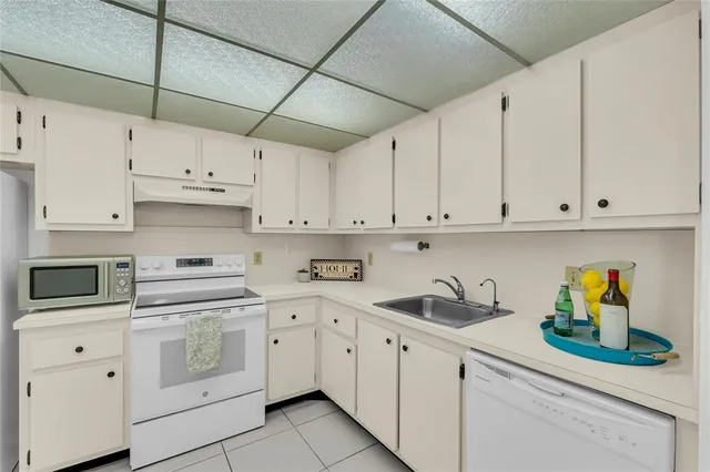 a kitchen with cabinets appliances and a sink