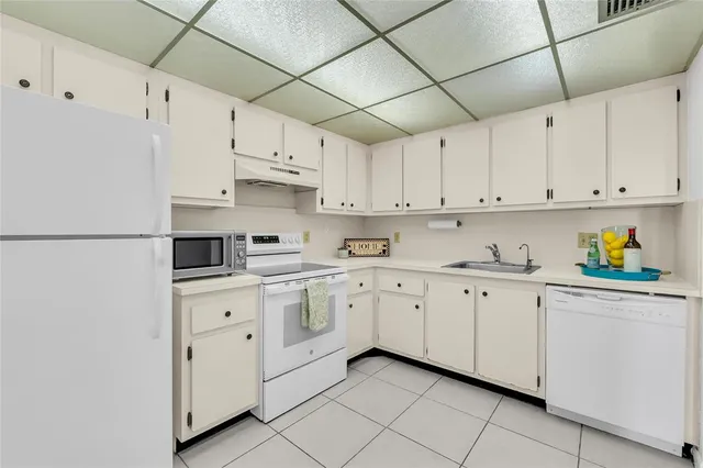 a kitchen with granite countertop cabinets stainless steel appliances and a sink