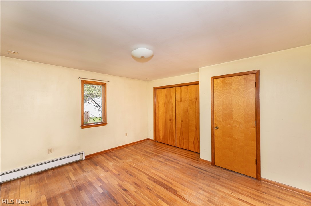 12310 Huntoon Road Painesville, OH 44077 - Photo 14 of 48 Generously sized primary bedroom with hardwood floors