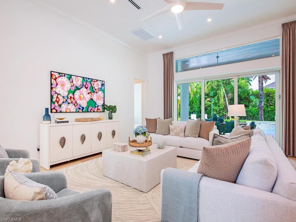 2363 Crayton Road Naples, FL 34103 - Photo 13 of 30 Spacious living area featuring large sliding glass doors, transom window, recessed lighting, and a ceiling fan