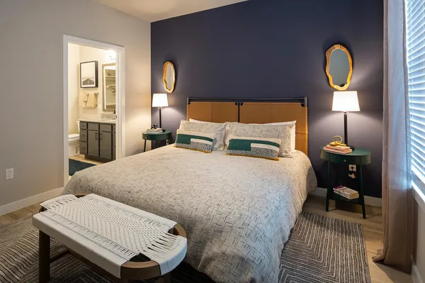 a bedroom with a bed and a lamp