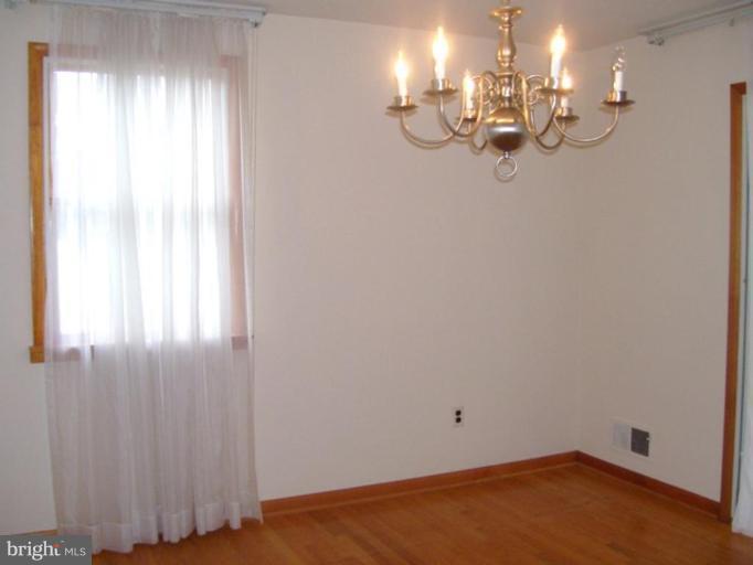 4407 Camellia Road Nottingham, MD 21236 - Photo 8 of 16 a view of a room with rack and chandelier