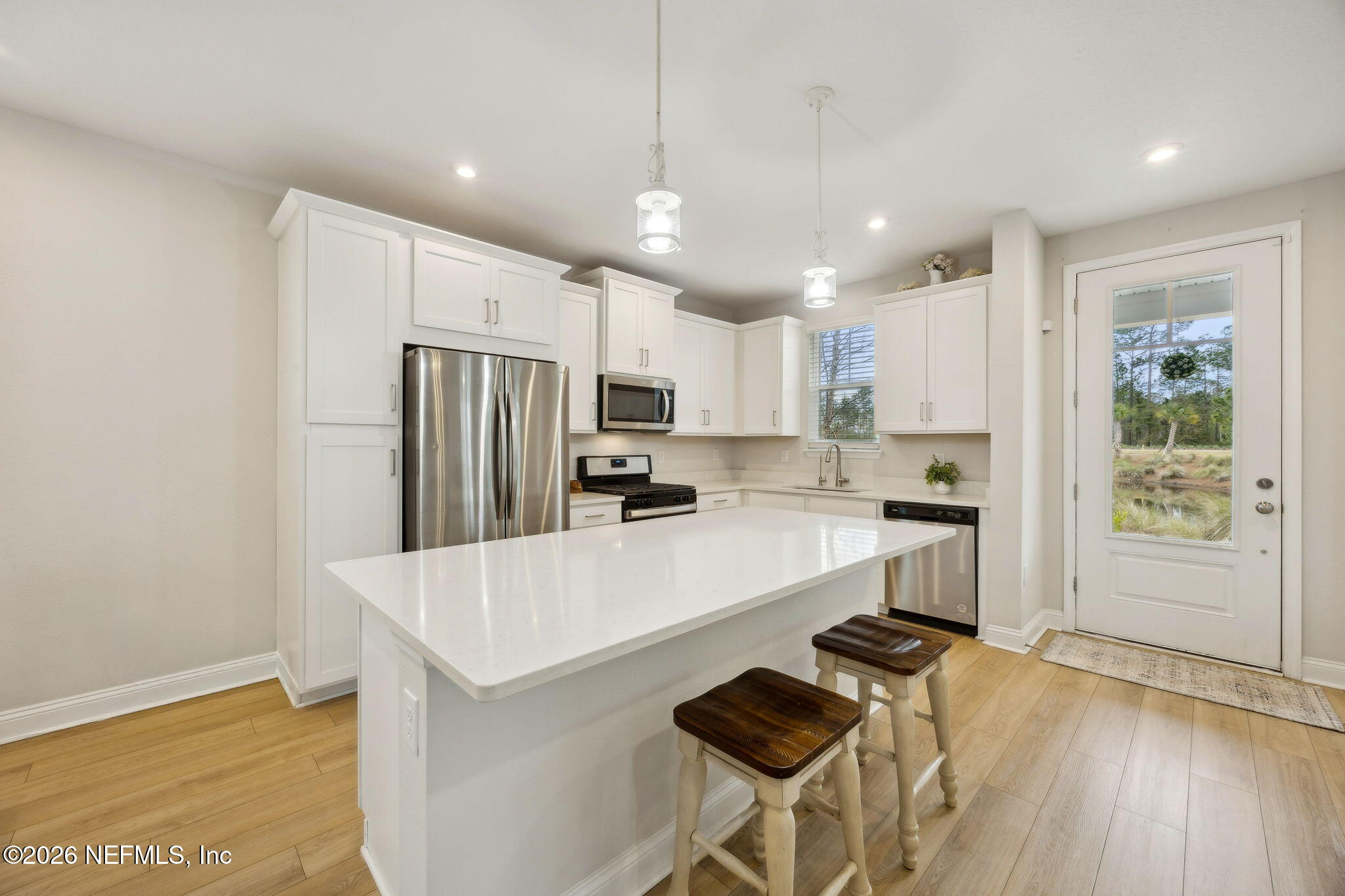 141 Redbud Lane Yulee, FL 32097 - Photo 13 of 77 a kitchen with stainless steel appliances a refrigerator sink and stove