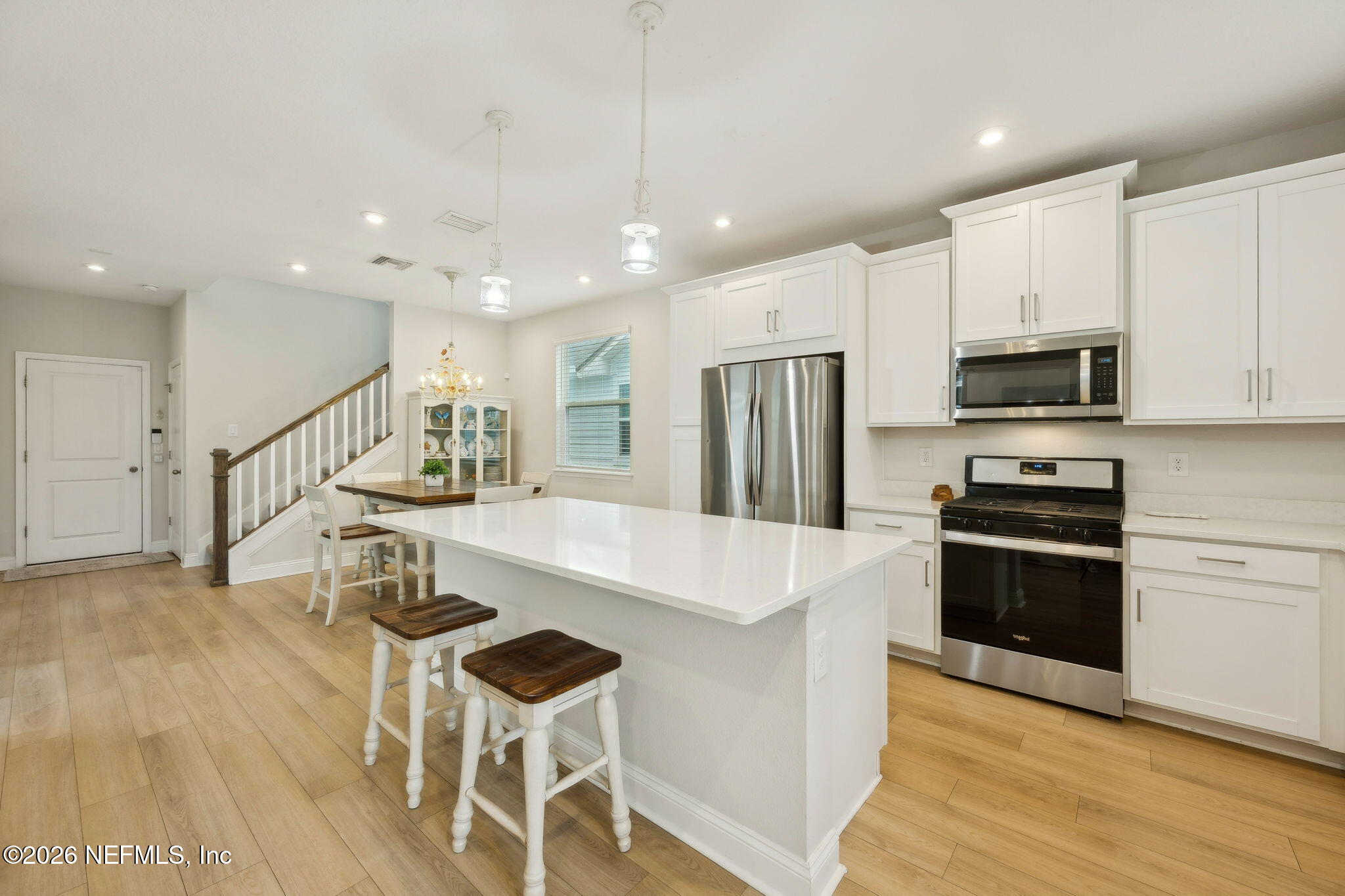 141 Redbud Lane Yulee, FL 32097 - Photo 14 of 77 a large white kitchen with wooden floor and a stove top oven