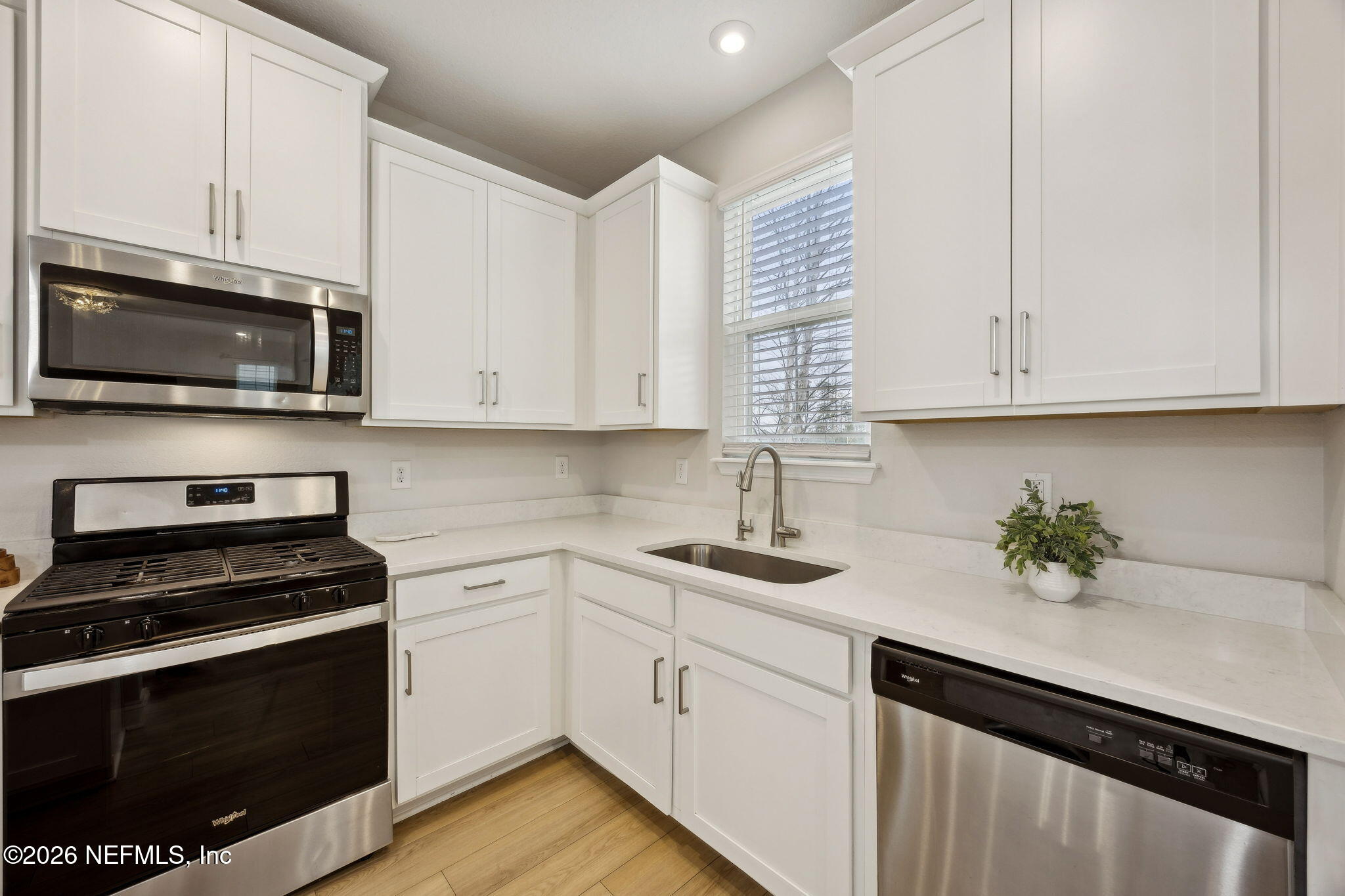 141 Redbud Lane Yulee, FL 32097 - Photo 15 of 77 a kitchen with granite countertop white cabinets appliances and a sink