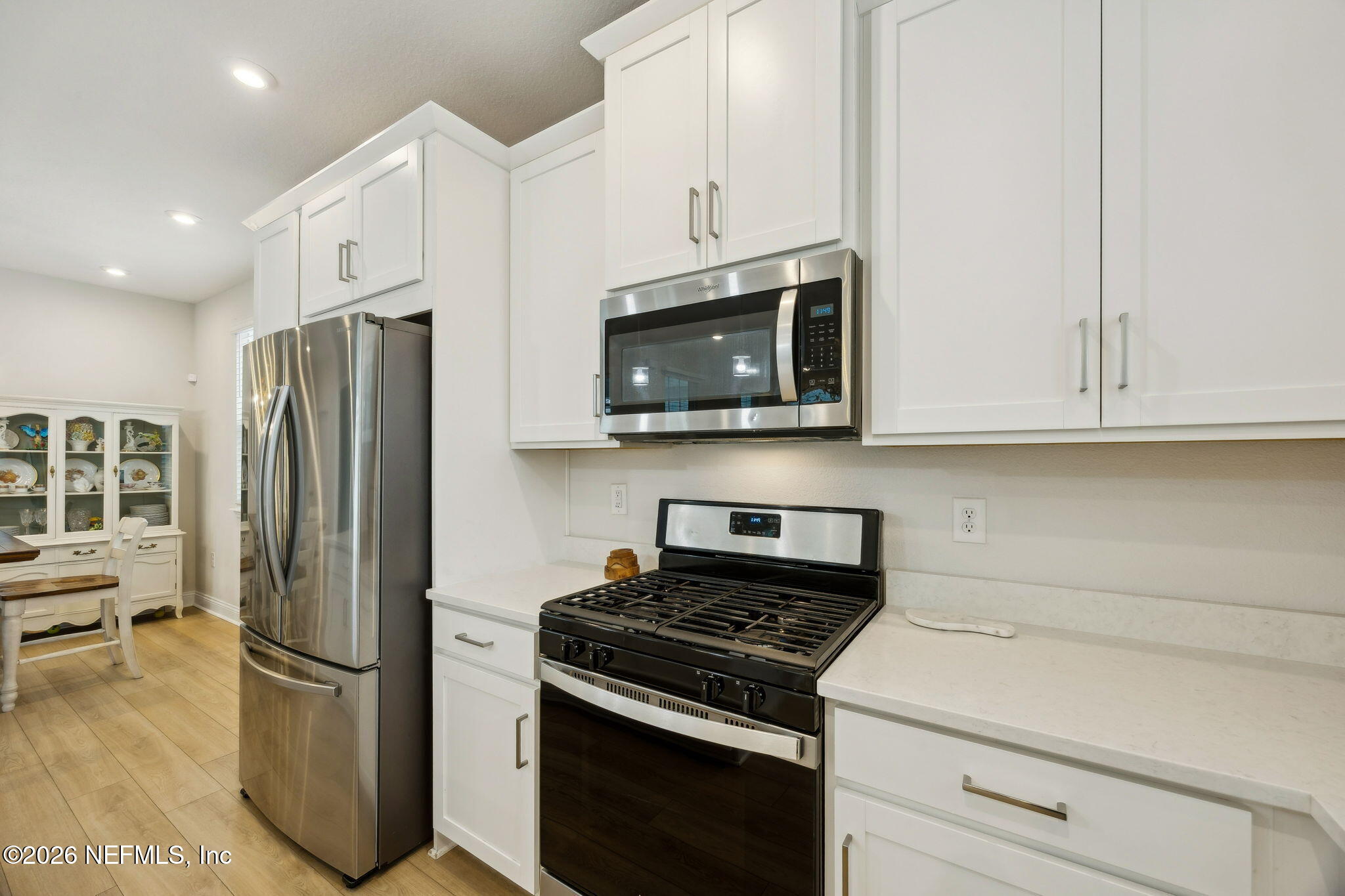 141 Redbud Lane Yulee, FL 32097 - Photo 16 of 77 a kitchen with stainless steel appliances a stove microwave and refrigerator
