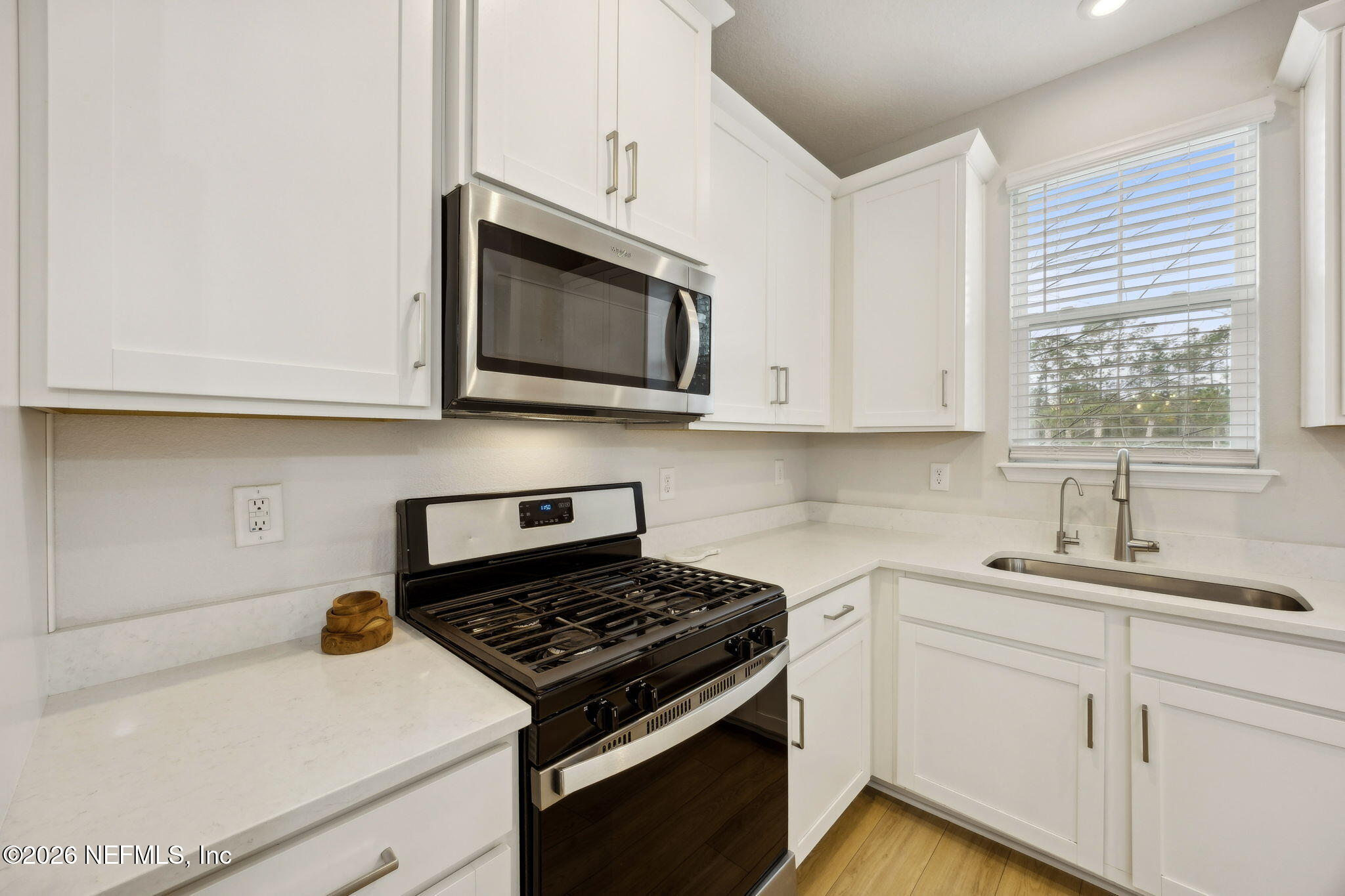 141 Redbud Lane Yulee, FL 32097 - Photo 18 of 77 a kitchen with granite countertop white cabinets stainless steel appliances and a window