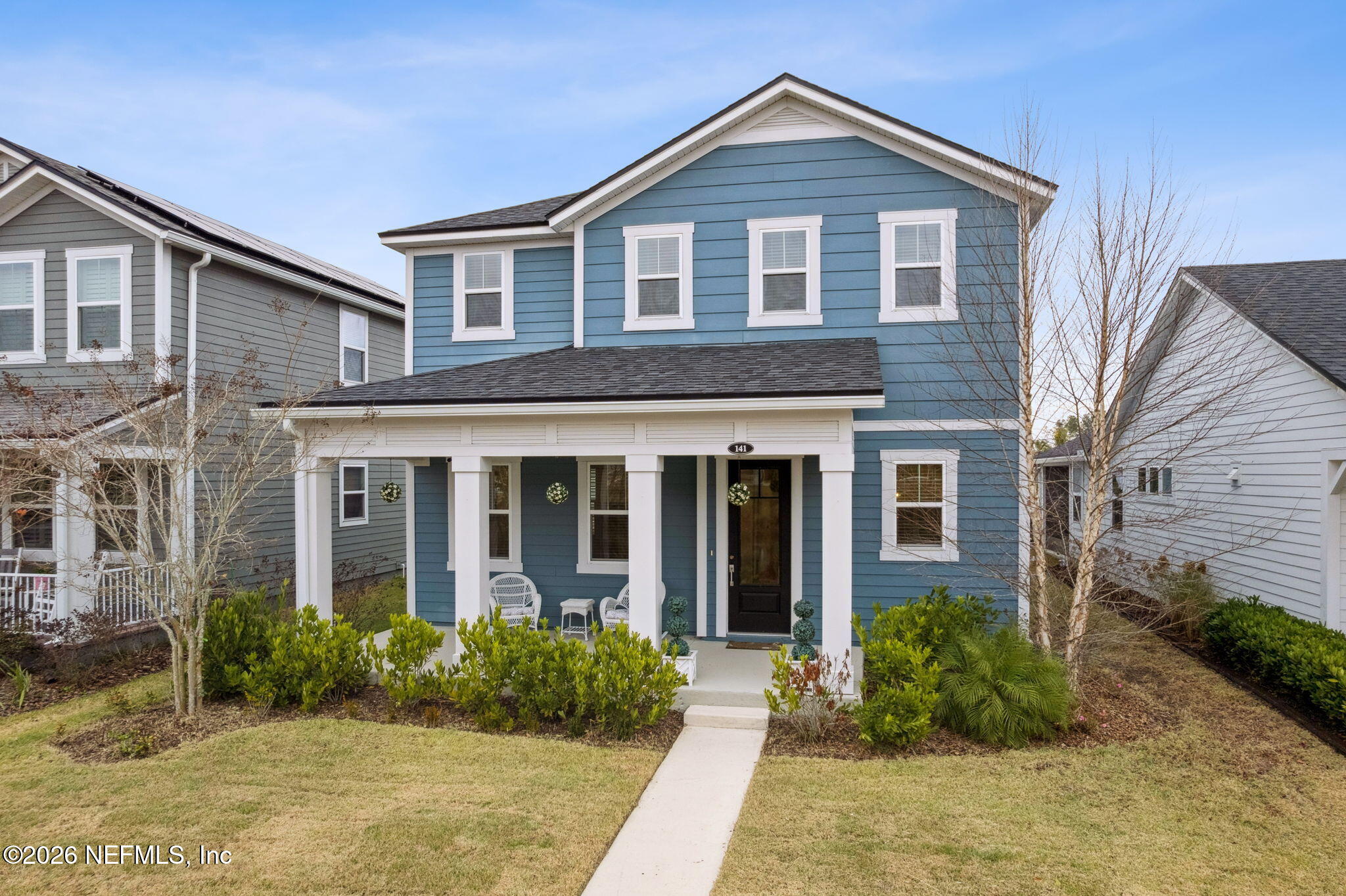 141 Redbud Lane Yulee, FL 32097 - Photo 2 of 77 a front view of a house with garden