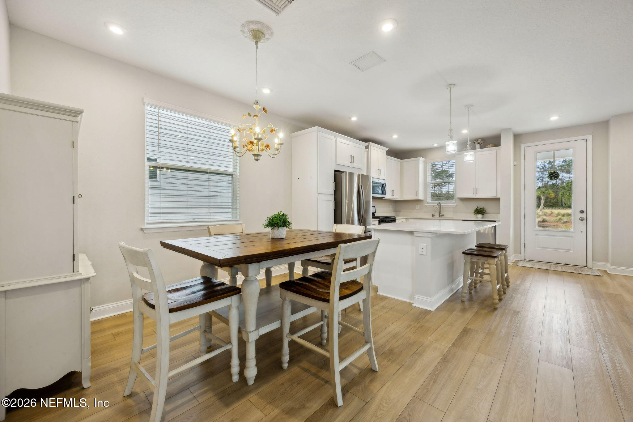 141 Redbud Lane Yulee, FL 32097 - Photo 24 of 77 a view of a dining room with furniture and wooden floor