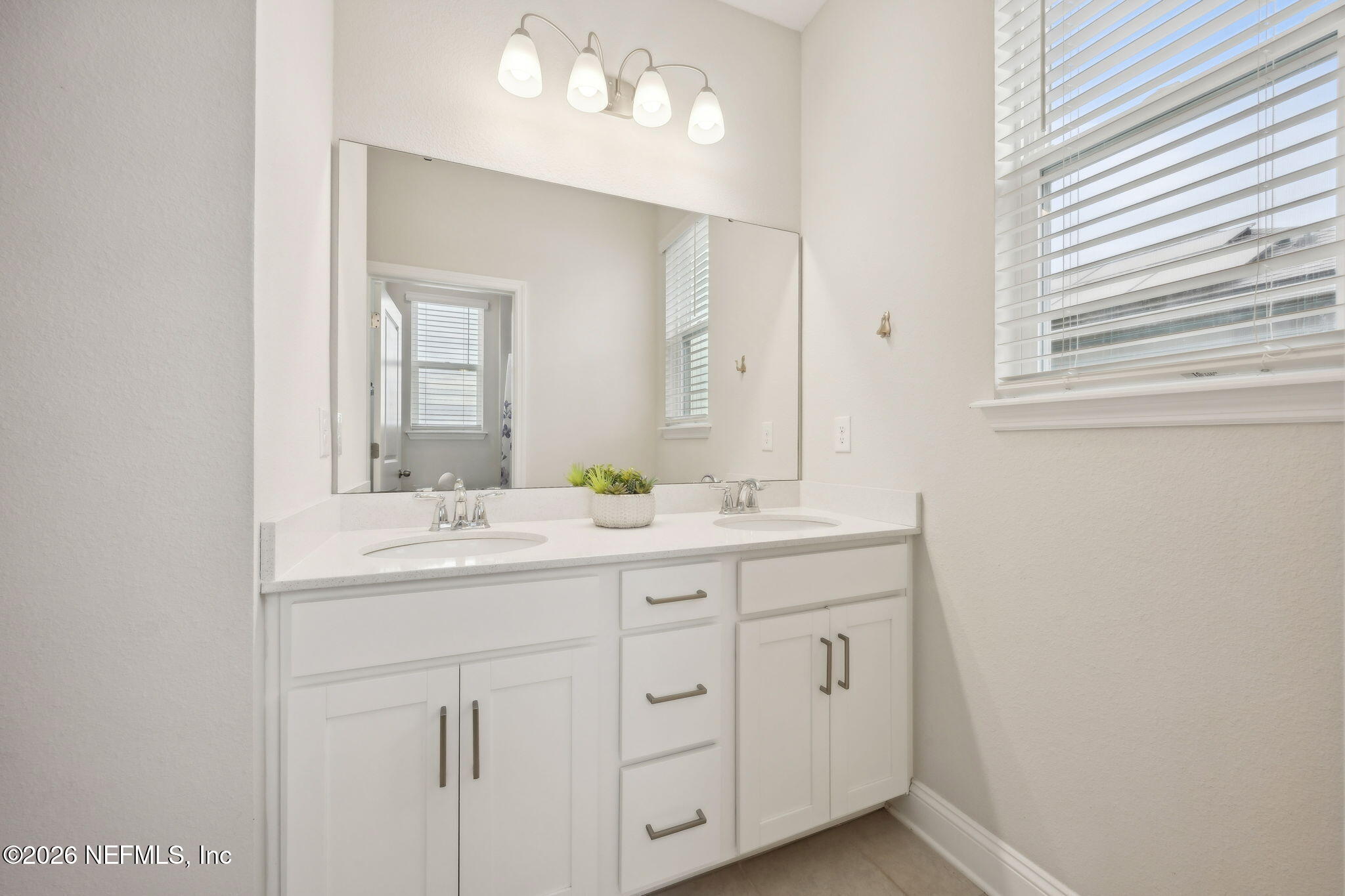 141 Redbud Lane Yulee, FL 32097 - Photo 38 of 77 a bathroom with a double vanity sink and mirror with window