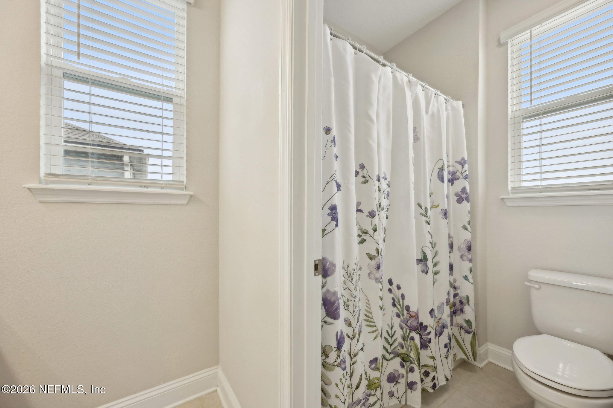141 Redbud Lane Yulee, FL 32097 - Photo 39 of 77 a white toilet sitting next to a shower curtain