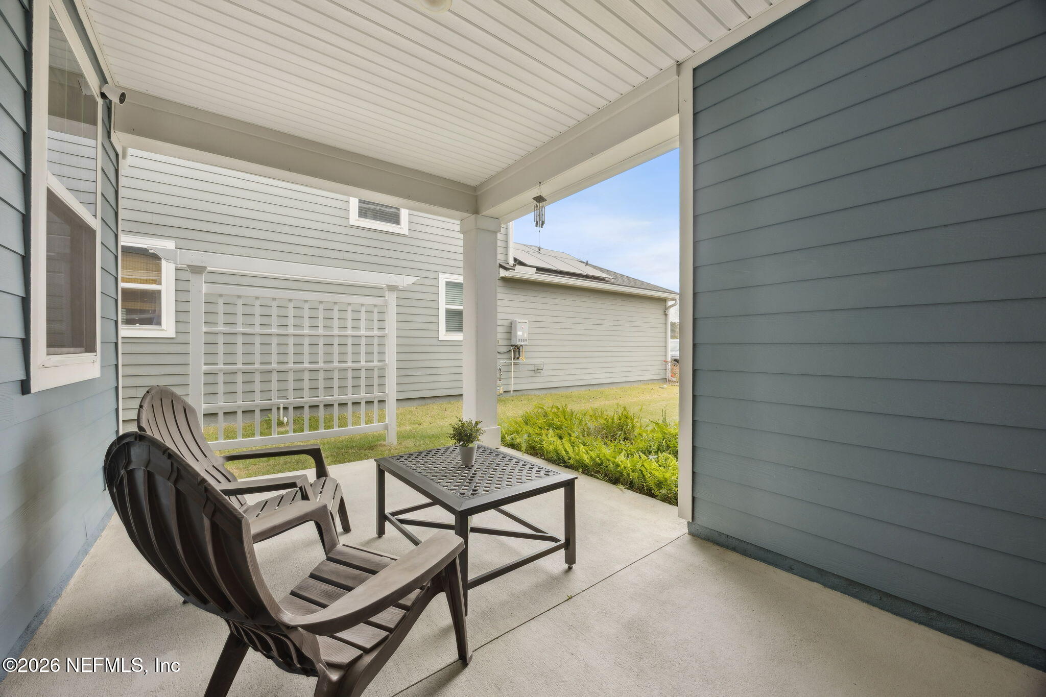 141 Redbud Lane Yulee, FL 32097 - Photo 43 of 77 a balcony with furniture and a gate