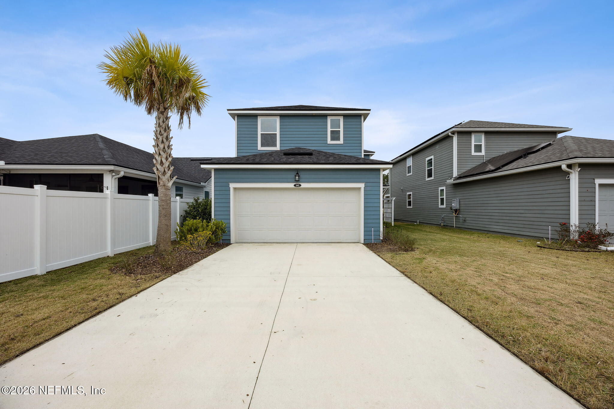 141 Redbud Lane Yulee, FL 32097 - Photo 48 of 77 a front view of a house with yard and garage