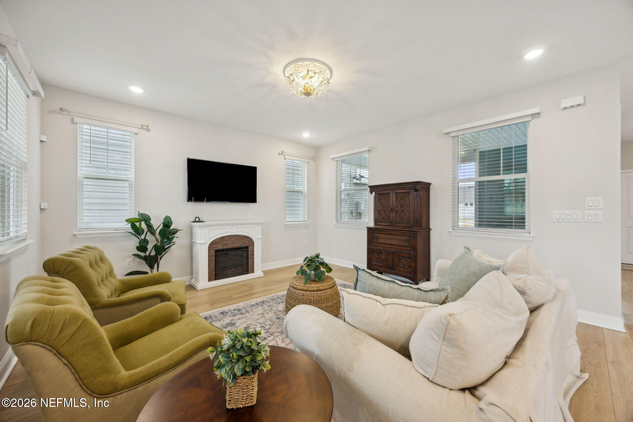 141 Redbud Lane Yulee, FL 32097 - Photo 9 of 77 a living room with furniture a fireplace and a flat screen tv