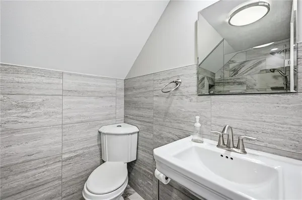 a bathroom with a glass shower door and a sink