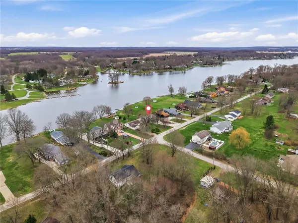 an aerial view of a house with pool outdoor space and lake view