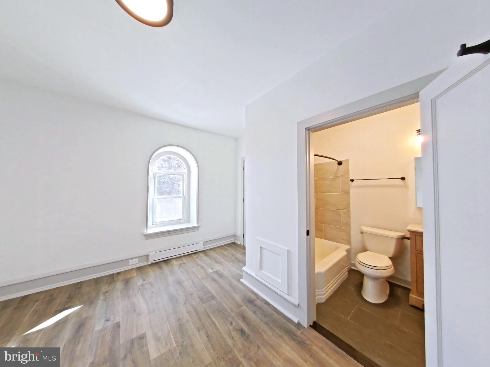 5606 Ridge Avenue, Unit 3F Philadelphia, PA 19128 - Photo 4 of 10 a bathroom with a toilet sink and a shower