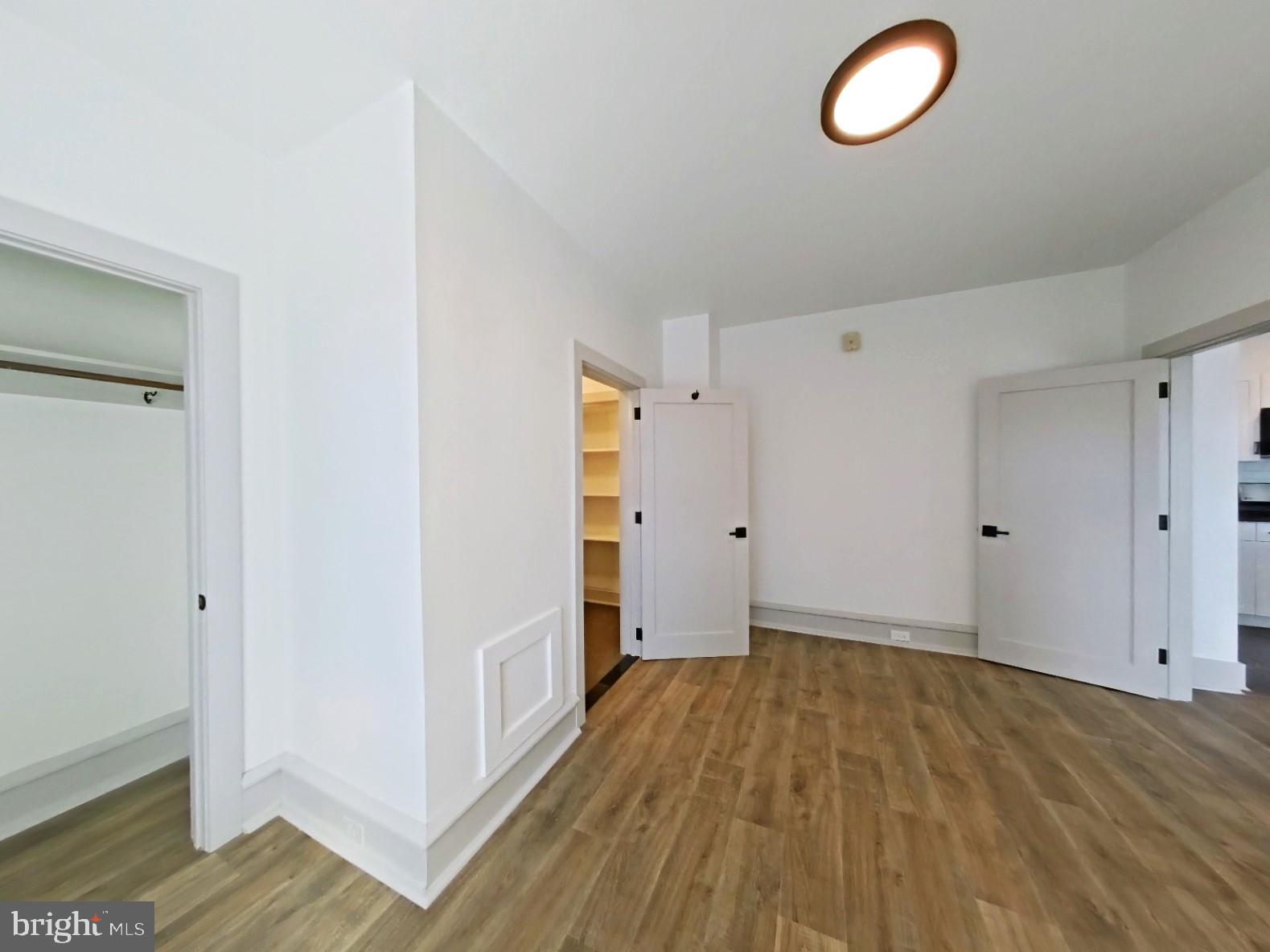 5606 Ridge Avenue, Unit 3F Philadelphia, PA 19128 - Photo 5 of 10 an empty room with wooden floor