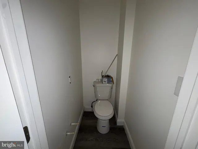a white toilet sitting in a bathroom