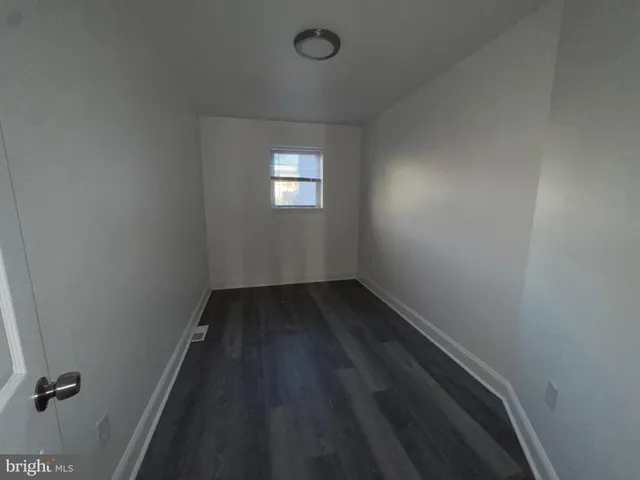 a view of a room with wooden floor and windows