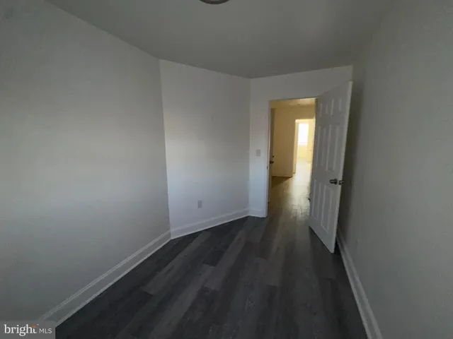 a view of a room with wooden floor and a window