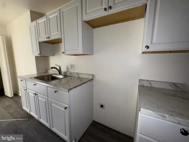 a kitchen with sink cabinets and a microwave oven