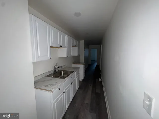 a kitchen with a sink and cabinets