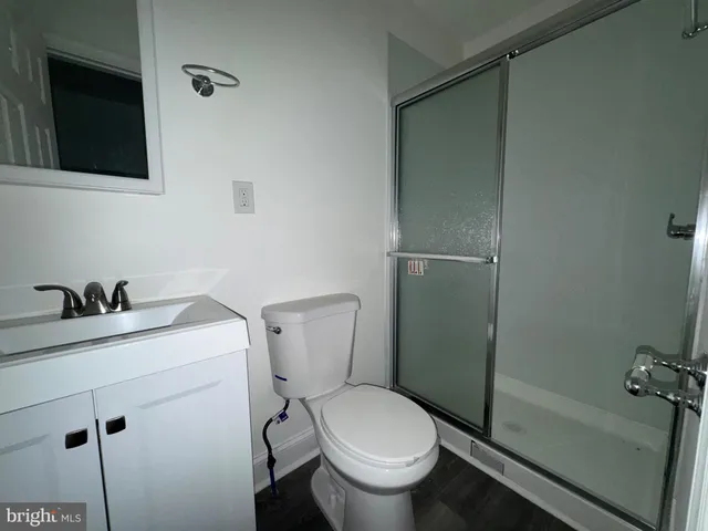 a white toilet sitting next to a bathroom sink