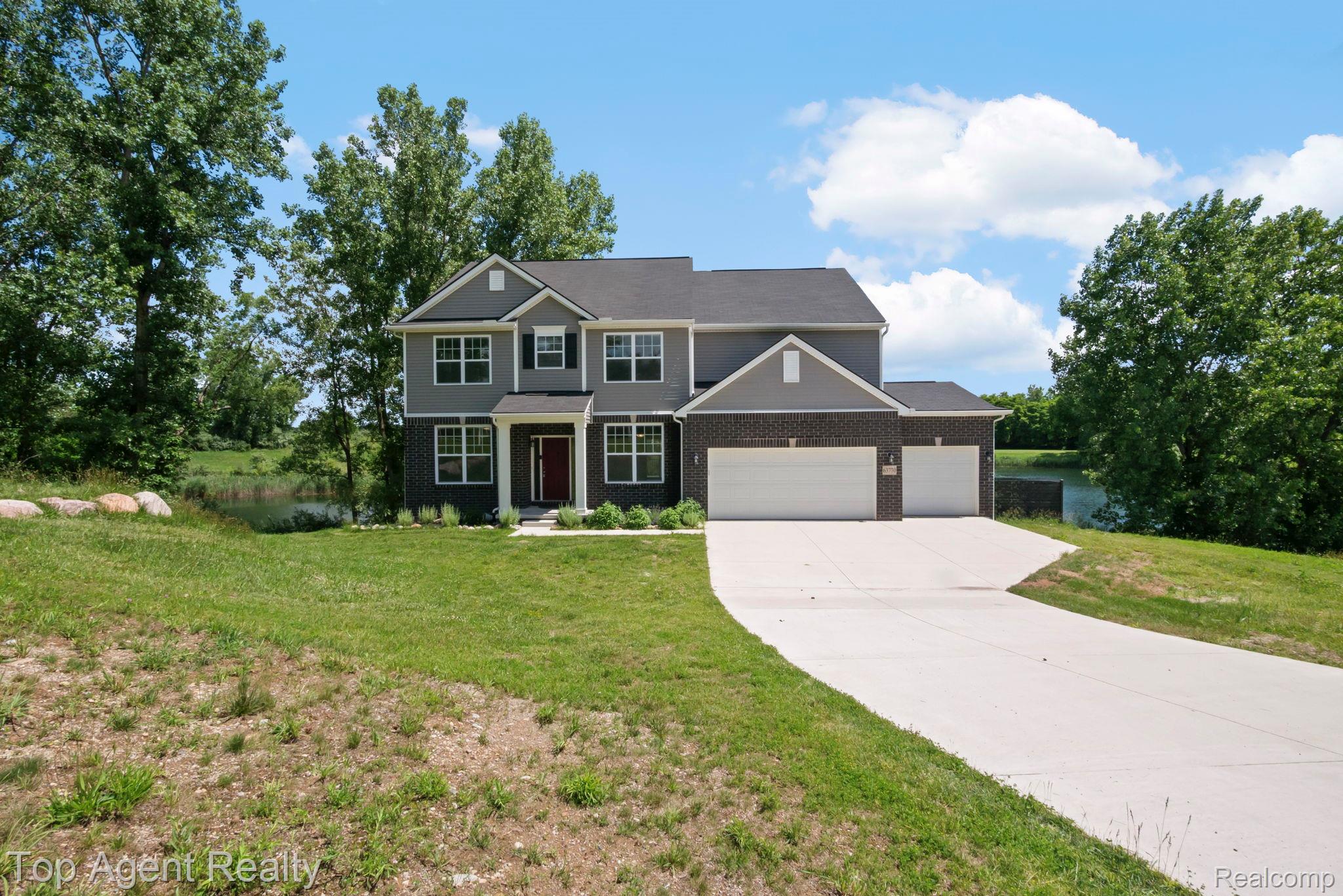 63770 Dequindre Road Washington, MI 48095 - Photo 55 of 61 Contemporary two-story residence with a dark gray siding and brick facade
