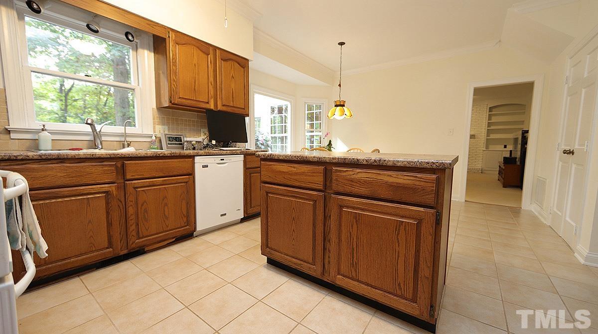 8700 Mourning Dove Road Raleigh, NC 27615 - Photo 11 of 30 a kitchen with stainless steel appliances granite countertop a sink and cabinets