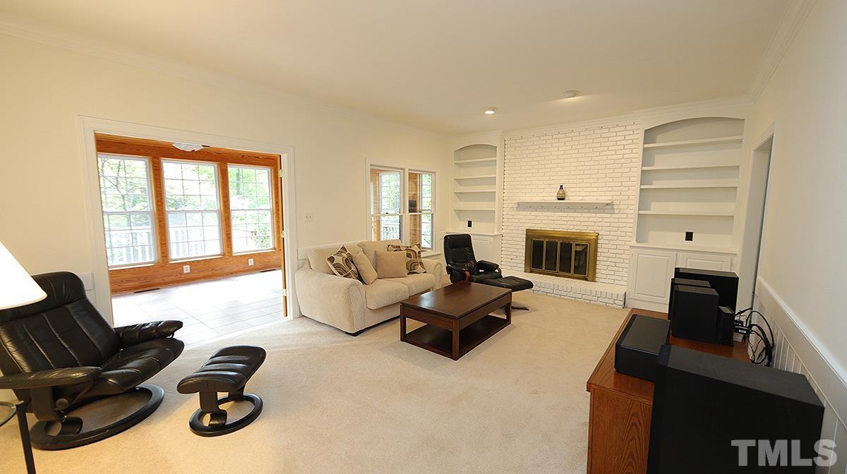 8700 Mourning Dove Road Raleigh, NC 27615 - Photo 14 of 30 a living room with furniture window and a fireplace