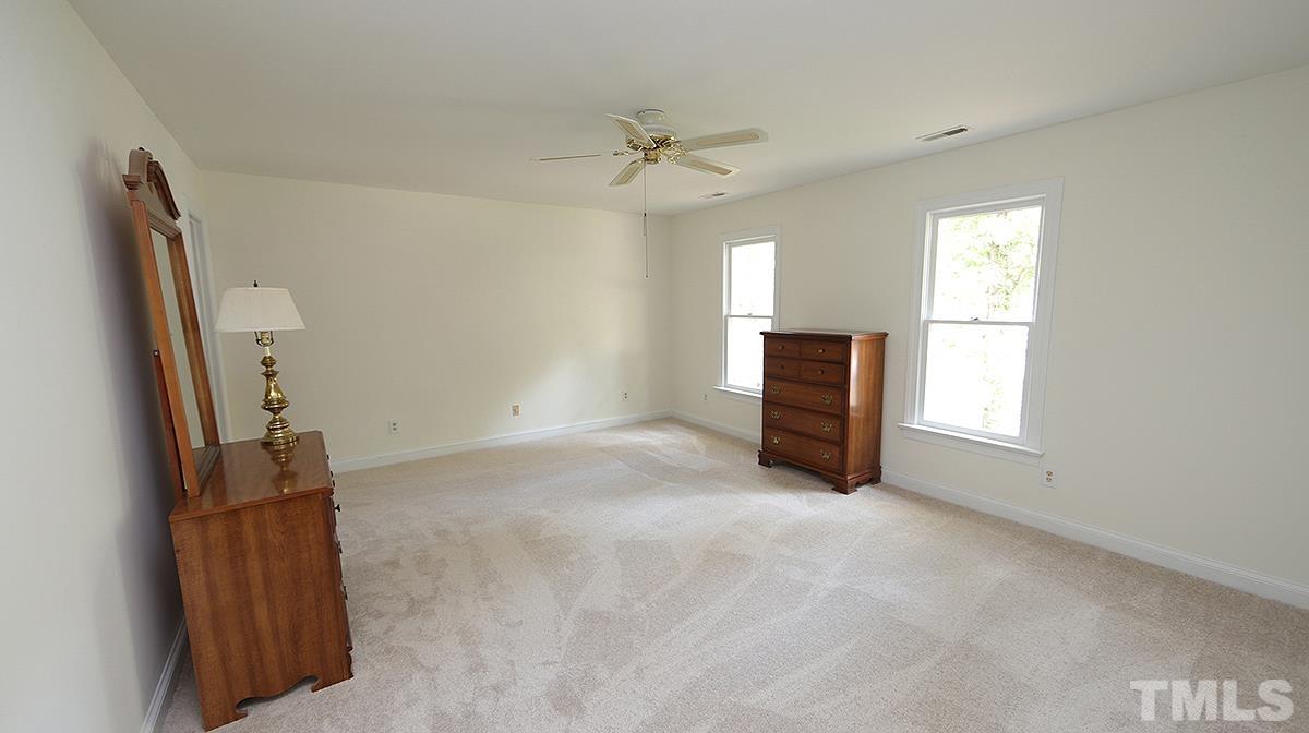 8700 Mourning Dove Road Raleigh, NC 27615 - Photo 19 of 30 a view of livingroom with hardwood floor and a ceiling fan