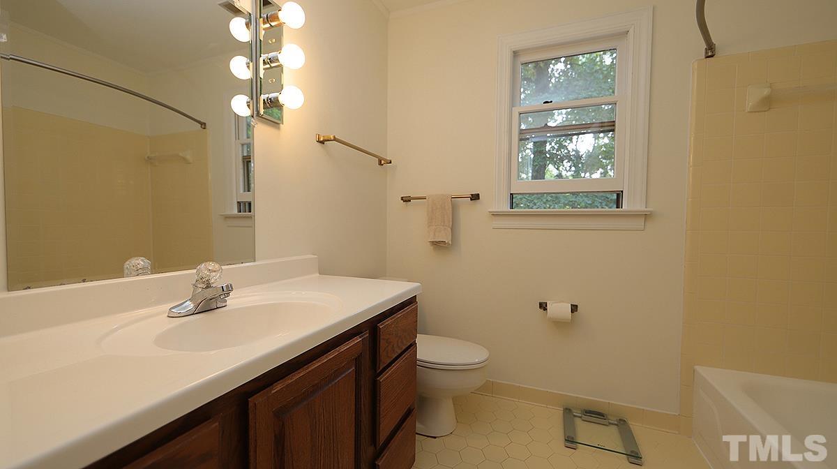 8700 Mourning Dove Road Raleigh, NC 27615 - Photo 23 of 30 a bathroom with a sink vanity granite and toilet