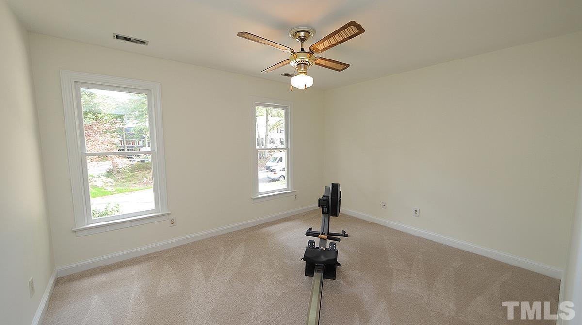 8700 Mourning Dove Road Raleigh, NC 27615 - Photo 24 of 30 a view of empty room with a ceiling fan and window