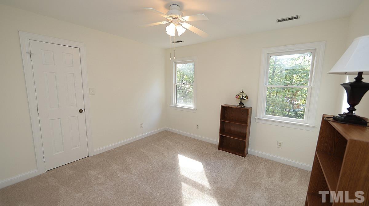 8700 Mourning Dove Road Raleigh, NC 27615 - Photo 25 of 30 a view of empty room with windows and fan