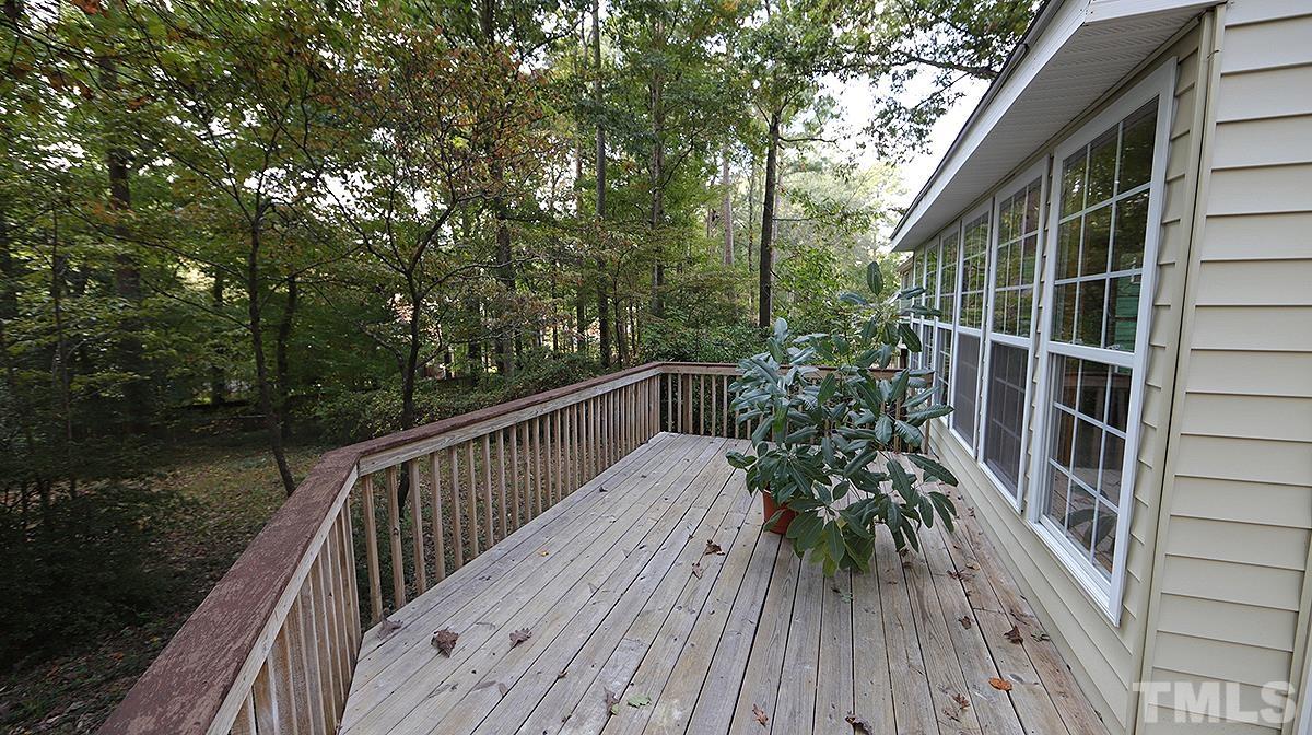 8700 Mourning Dove Road Raleigh, NC 27615 - Photo 28 of 30 a balcony with wooden floor and trees in the back