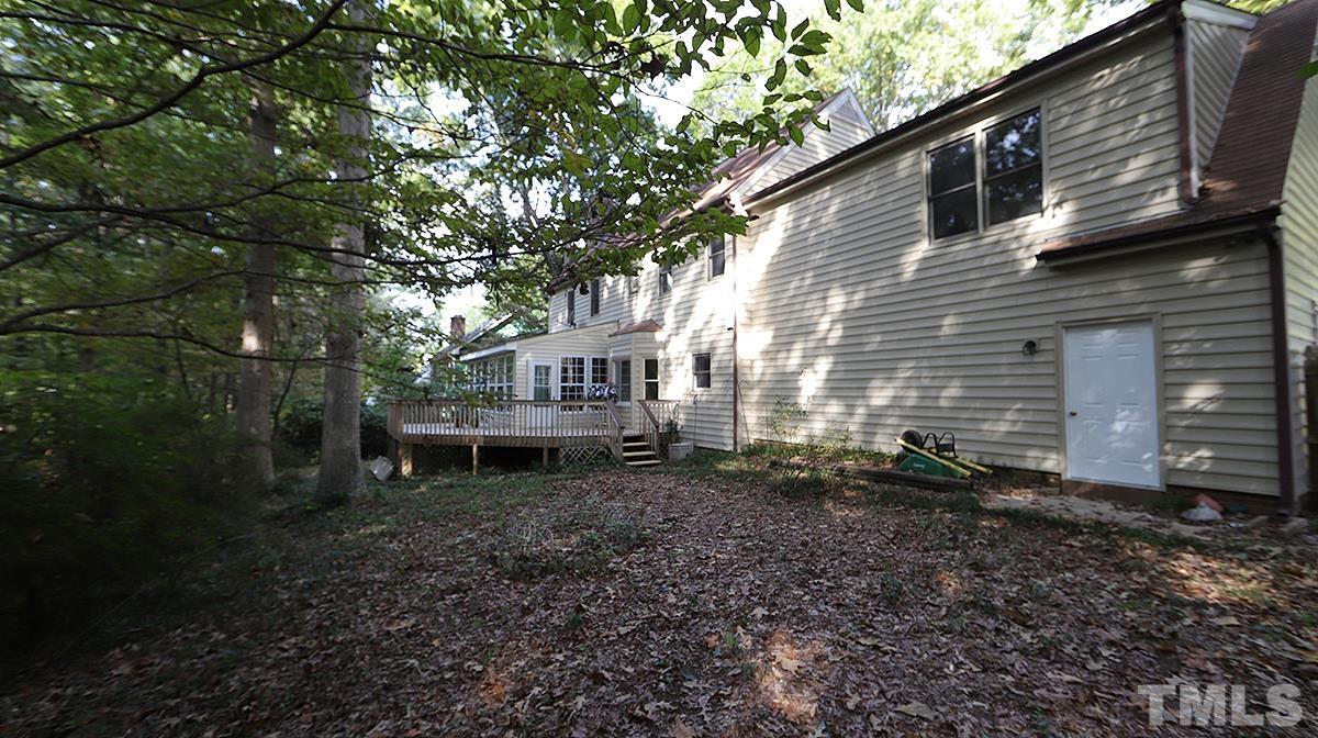 8700 Mourning Dove Road Raleigh, NC 27615 - Photo 30 of 30 a backyard of a house with a garden and barbeque oven