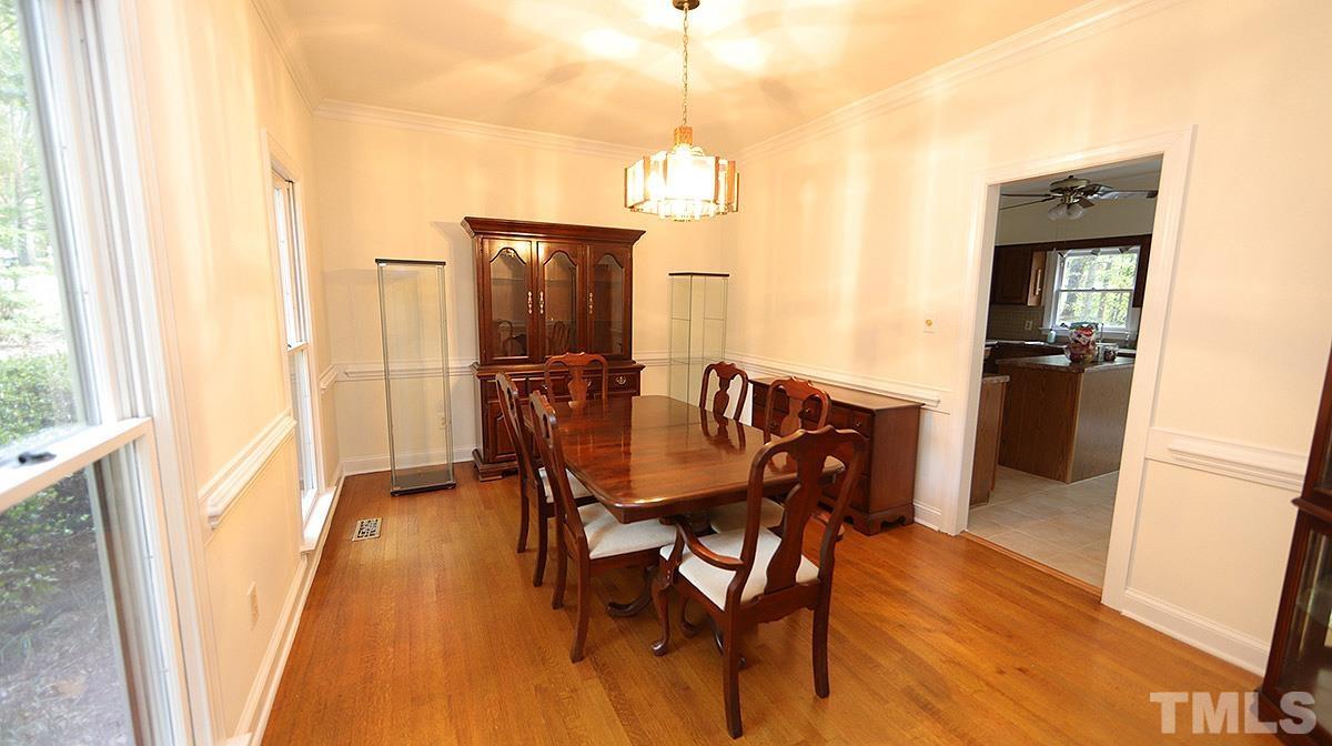 8700 Mourning Dove Road Raleigh, NC 27615 - Photo 7 of 30 a view of a dining room with furniture window and wooden floor